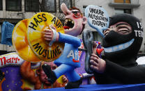 <p>A carnival float with papier-mache caricature mocking the Anti-immigration party Alternative for Germany (AfD) is shown at the Rose Monday parade in Duesseldorf, Germany, Feb. 27, 2017. REUTERS/Wolfgang Rattay </p>