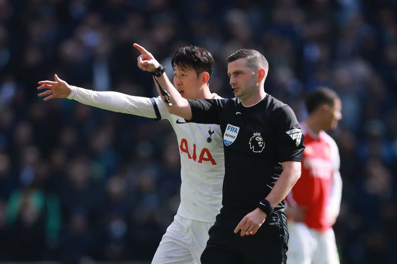 Son Heung-Min with Referee Michael Oliver during the Premier League match between Tottenham Hotspur and Arsenal FC at Tottenham Hotspur Stadium.
