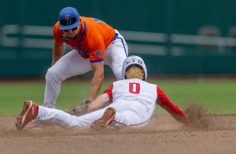 N.C State left fielder Luke Nixon (0) is tagged out trying to steal second base by Florida short stop Colby Shelton (10) in the sixth inning during game seven of the College World Series on Monday, June 17, 2024 at Charles Schwab Field in Omaha, Nebraska.