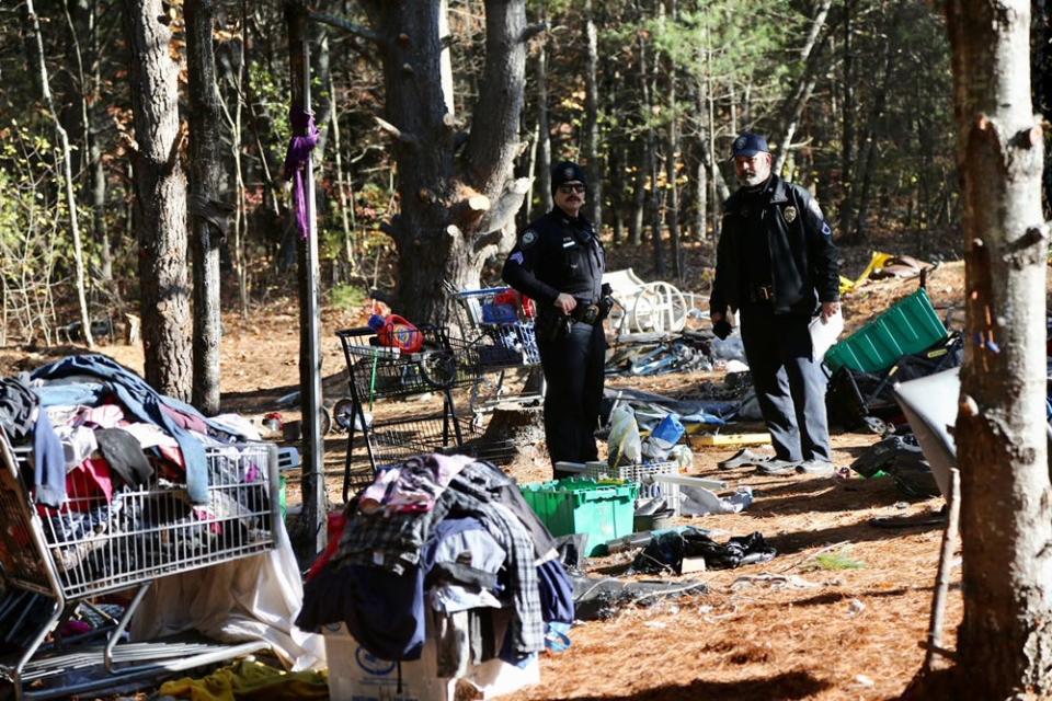 Somersworth police office arrive to cleaer homeless encampments on Garabedian Trust owned property near Willand Pond Monday, Nov. 8, 2021.
