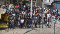 Protesters hurl stones during a clash between anti CAA and pro CAA demonstrations, at Bhajanpura on February 24, 2020 in New Delhi, India. A Delhi Police cop and three civilians have died, a DCP-rank officer injured, a petrol pump torched, a number of houses, cars and shops burnt after clashes between pro and anti-CAA protesters in Maujpur and Jafarabad areas of North East Delhi. There was tension in the area after hundreds of anti-CAA protesters, mostly women, blocked a road near the Jaffrabad metro station connecting Seelampur with Maujpur and Yamuna Vihar. (Photo by Sanchit Khanna/Hindustan Times)