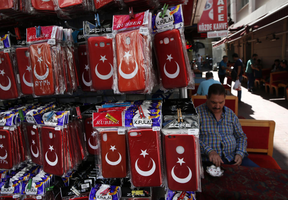 In this Monday, Aug. 20, 2018 photo, phone cases are offered for sale near the historic Sultanahmet district of Istanbul, one of the city's main tourist attractions. Tourists have returned in droves to Turkey according to the government figures, helped this summer by the sharp fall in the value of the Turkish lira following economic uncertainty and a rift with the United States. (AP Photo/Lefteris Pitarakis)