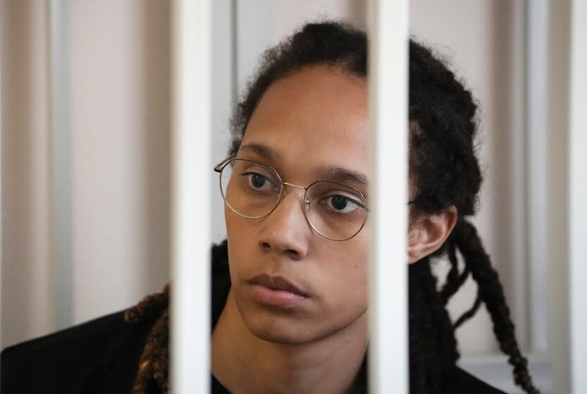 WNBA star and two-time Olympic gold medalist Brittney Griner sits in a cage at a court room prior to a hearing