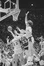 FILE - Boston Celtics forward Larry Bird (33) attempts a shot through defending Los Angeles Lakers forward Kurt Rambis (31), right and center Kareem Abdul Jabbar during NBA Championship series match on June 8, 1985, at the Forum in Inglewood, Calif. (AP Photo/Lennox McLendon)