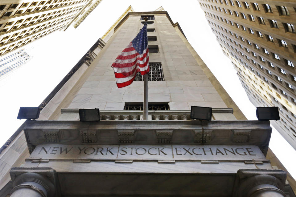 The American flag flies above the Wall Street entrance to the New York Stock Exchange. (AP Photo/Richard Drew, File)