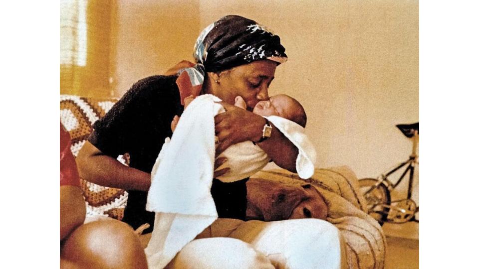 Meghan Markle as baby being cradled by her maternal grandmother Jeanette