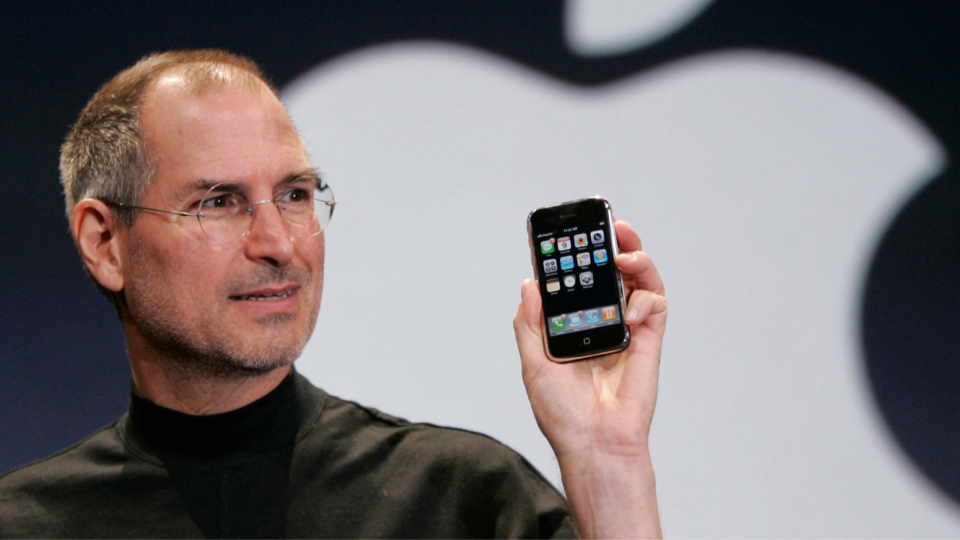 Steve Jobs holding first iPhone