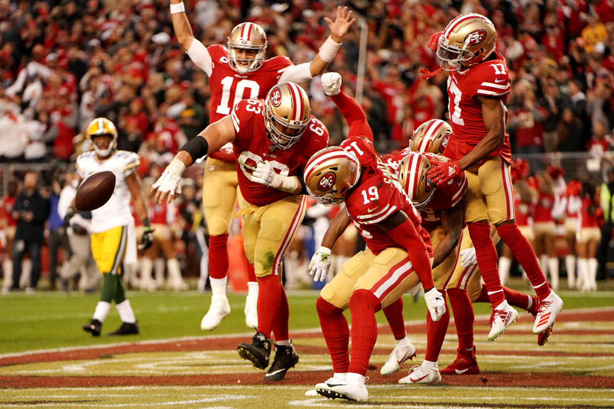 Jimmy Garoppolo (10) and Ben Garland (63) of the San Francisco 49ers celebrate a touchdown by Raheem Mostert. (Photo by Thearon W. Henderson/Getty Images)