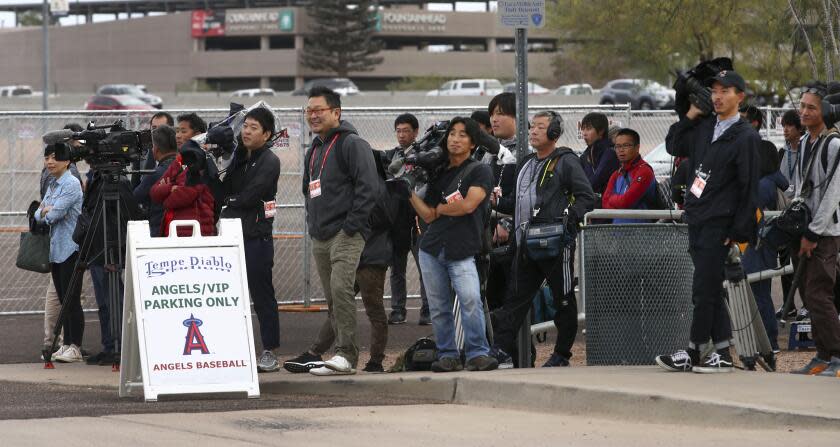 Members of the media await the arrival of Los Angeles Angels baseball player Shohei Ohtani at Tempe Diablo Stadium on Tuesday, Feb. 13, 2018, in Tempe, Ariz. (AP Photo/Ben Margot)