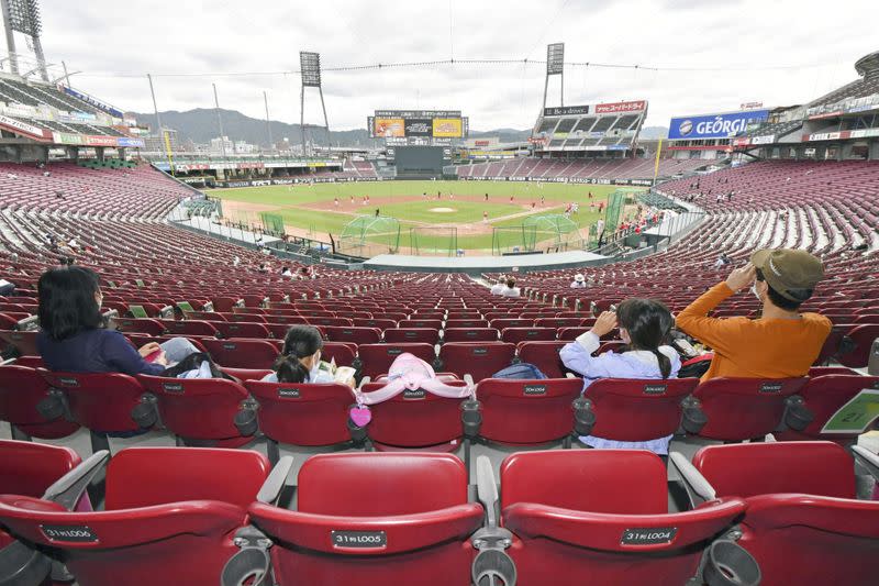 Spectators watch professional baseball team Hiroshima Toyo Carp's practice at its baseball stadium in Hiroshima