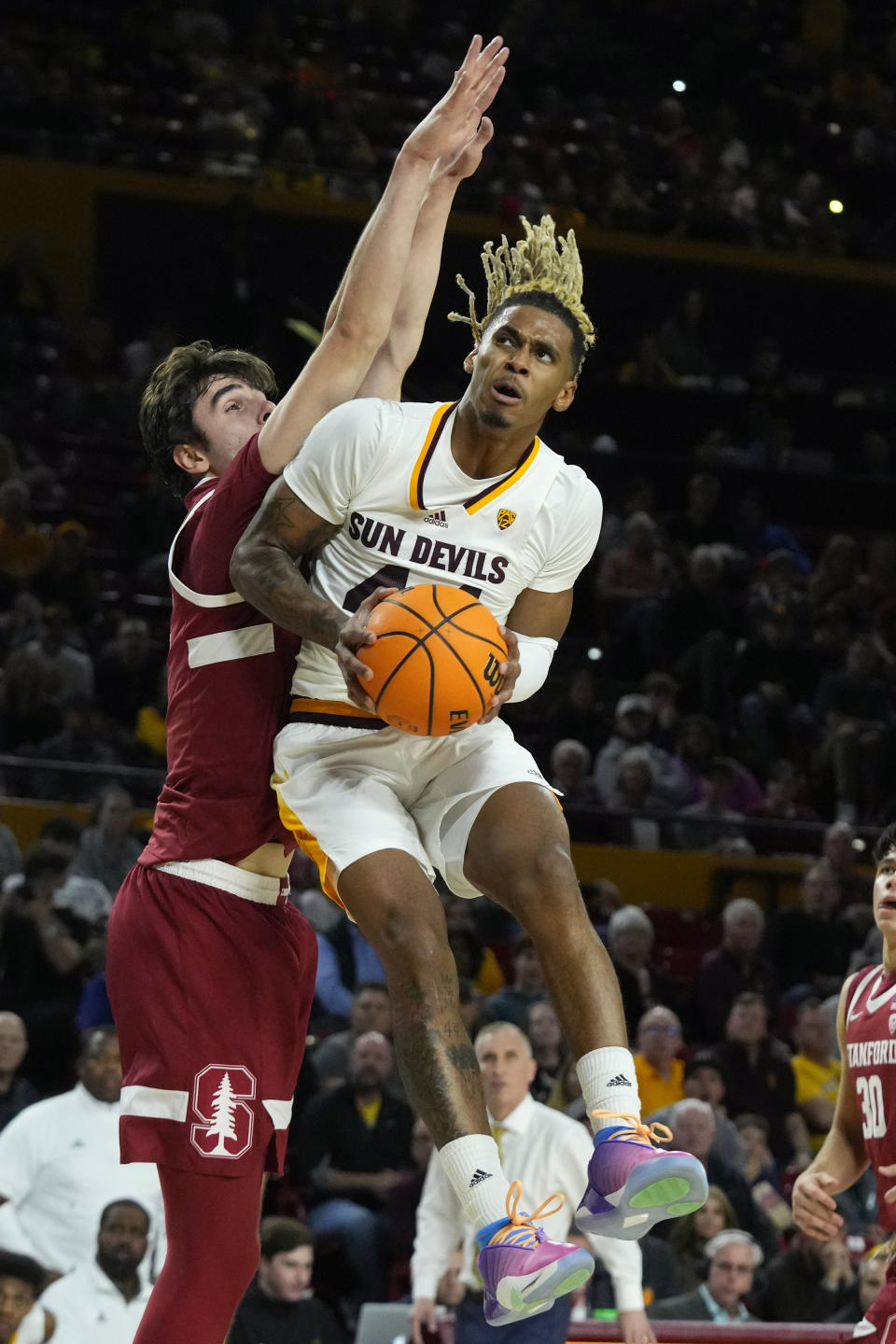 Arizona State guard Adam Miller, right, drives past Stanford forward Maxime Raynaud, left, during the second half of an NCAA college basketball game Thursday, Feb. 1, 2024, in Tempe, Ariz. Stanford won 71-62. (AP Photo/Ross D. Franklin)