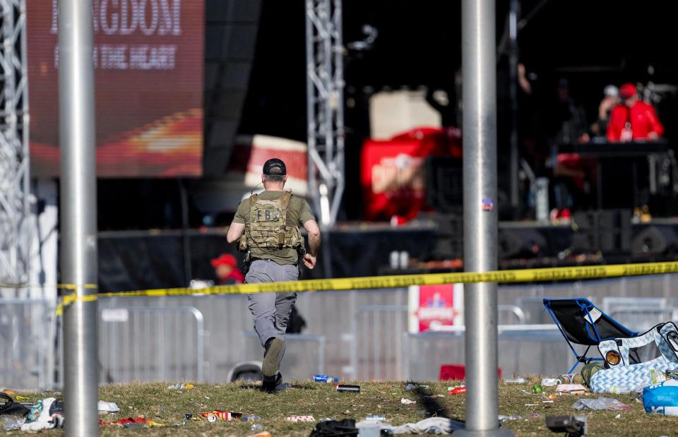 An FBI agent runs toward Union Station after a shooting following the Kansas City Chiefs Super Bowl LVIII victory parade