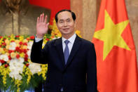 FILE PHOTO: Vietnamese President Tran Dai Quang greets journalists as he waits for the arrival of Russian Foreign Minister Sergei Lavrov (not pictured) at the Presidential Palace in Hanoi, Vietnam March 23, 2018. Minh Hoang/Pool via REUTERS/File Photo