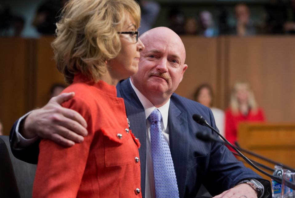 Gabrielle Giffords testifies on gun violence as her husband Mark Kelly looks on.