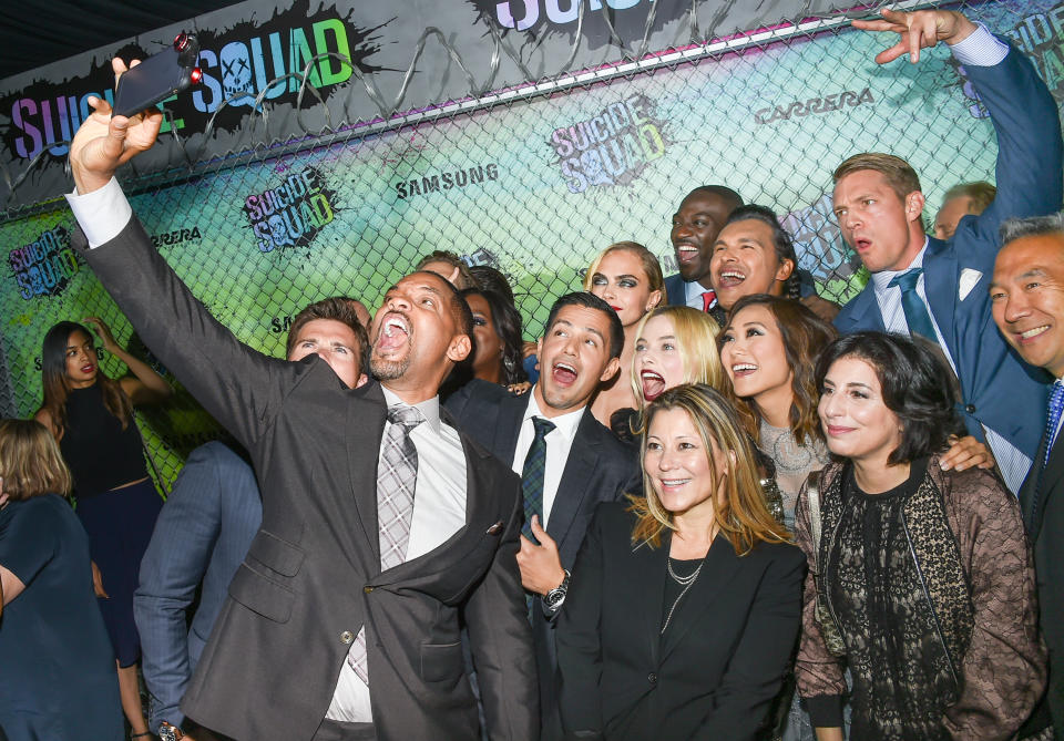 Actors Will Smith, left, Jay Hernandez, Margot Robbie, Cara Delevingne, Adam Beach and Adewale Akinnuoye-Agbaje pose for selfie on the rd carpet at the world premiere of "Suicide Squad" at the Beacon Theatre on Monday, Aug. 1, 2016, in New York. (Photo by Evan Agostini/Invision/AP)