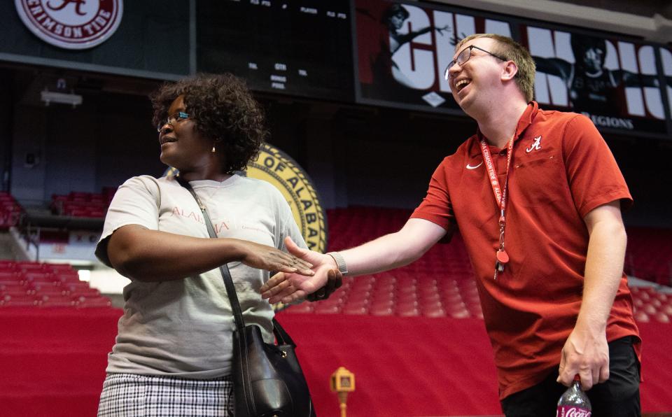 May 5, 2022; Tuscaloosa, AL, USA; The Crossing Points Program at the University of Alabama rehearsed for the program's first ever graduation Thursday at Coleman Coliseum. Program director Kagendo Mutua shakes hands with Colby Spangler as they practice the graduation. Mandatory Credit: Gary Cosby Jr.-The Tuscaloosa News