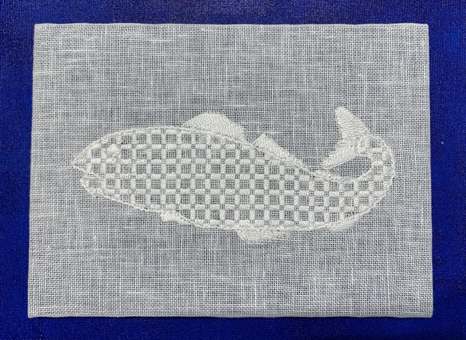 One of 40 renditions of a cod drawing on show at the St. John's exhibit. The Mountmellick style typically uses heavier fabric and white thread.