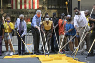 Mayor Bill de Blasio, third from left, participates in painting Black Lives Matter on Fifth Avenue in front of Trump Tower, Thursday, July 9, 2020, in New York. The mayor's wife, Chirlane McCray, is fourth from left and Rev. Al Sharpton is second from left. (AP Photo/Mark Lennihan)