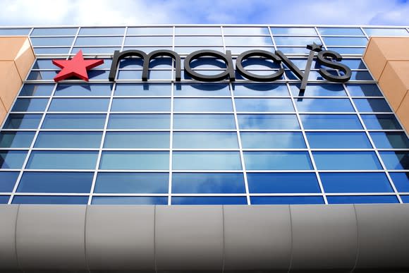 A Macy's store sign viewed up from street level.