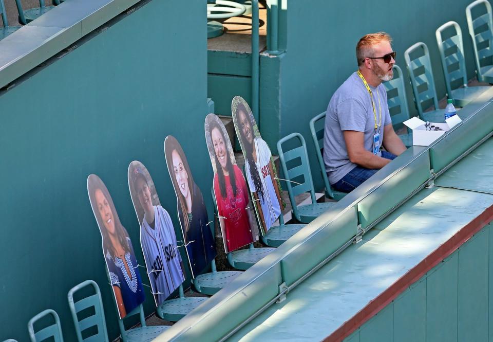 <p>Pictures of fans sit on top of the Green Monster before the exhibition game against the Toronto Blue Jays on July 22 in Boston.</p>