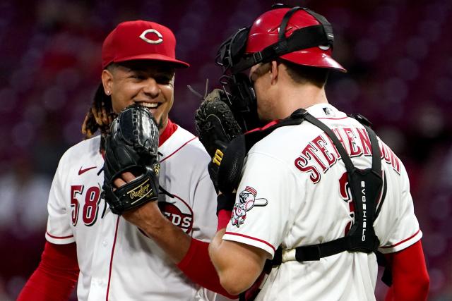Cincinnati Reds starting pitcher Luis Castillo (58) and Cincinnati Reds catcher Tyler Stephenson (37) share a laugh during a mound visit in the sixth inning of a baseball game against the St. Louis Cardinals, Monday, Aug. 30, 2021, at Great American Ball Park in Cincinnati. The St. Louis Cardinals won, 3-1.