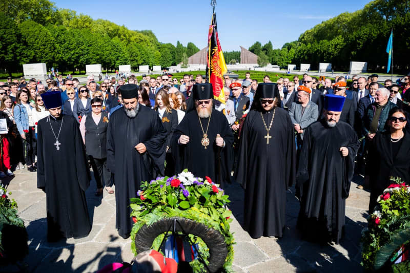 Russian Orthodox clergymen stand in front of memorial wreaths at the Soviet memorial in Treptow Park. May 8 and 9 marks the 79th anniversary of Nazi Germany's unconditional surrender in World War II (WWII). Christoph Soeder/dpa