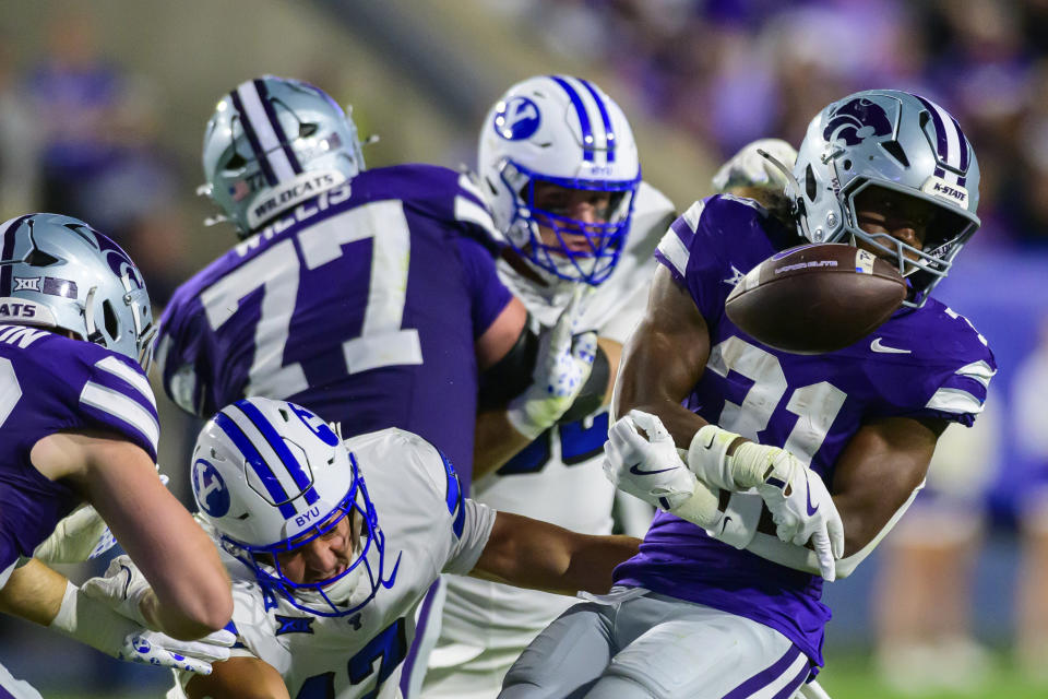 BYU linebacker Jack Kelly, bottom center, forces Kansas State running back DJ Giddens (31) to fumble the football during an NCAA college football game, Saturday, Sept. 21, 2024, in Provo, Utah. (AP Photo/Tyler Tate)