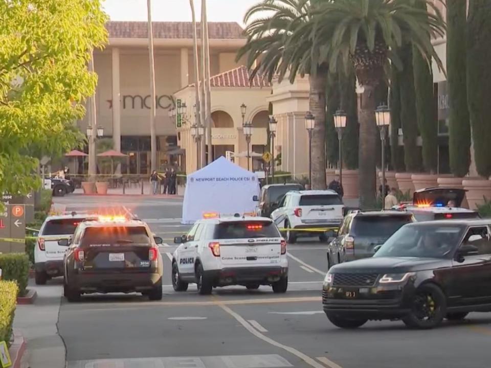 Newport Beach police block access to a street where a 68-year-old woman from New Zealand was killed after she was hit by a car driven by suspects who tried to rob her at the Fashion Island mall in July 2024 (screengrab/KTLA5)