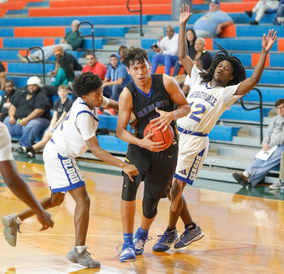 Auburndale defenders (2) Milton Smith and (12) Dorian Allen try to trap Charlotte (12) Tre Carroll  during the Stinger Shootout in Bartow, Florida  February 8, 2020.      [PIERRE DUCHARME/THE LEDGER]