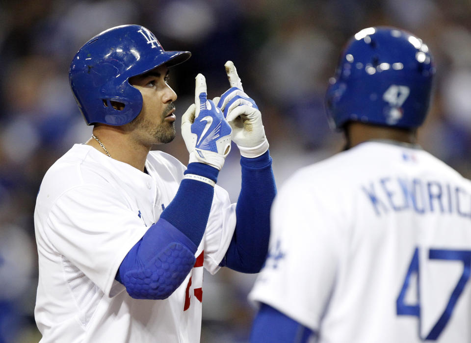 Los Angeles Dodgers&#39; Adrian Gonzalez, left, points to the sky after hitting a home run against the San Diego Padres during the first inning of a baseball game in Los Angeles, Wednesday, April 8, 2015. Dodgers&#39; Howie Kendrick, right, is the on deck batter. (AP Photo/Alex Gallardo)