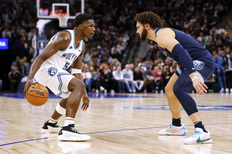 Minnesota Timberwolves guard Anthony Edwards (5) is defended by Memphis Grizzlies forward David Roddy during the second half of an NBA basketball game Thursday, Jan. 18, 2024, in Minneapolis. (AP Photo/Matt Krohn)