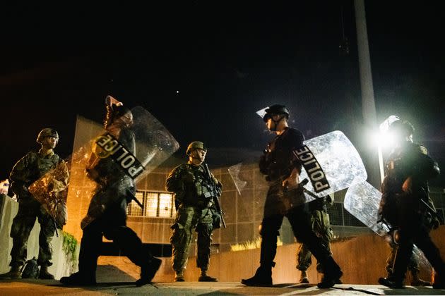 National Guard troops stand guard inside of a fenced area in Kenosha, Wisconsin. 