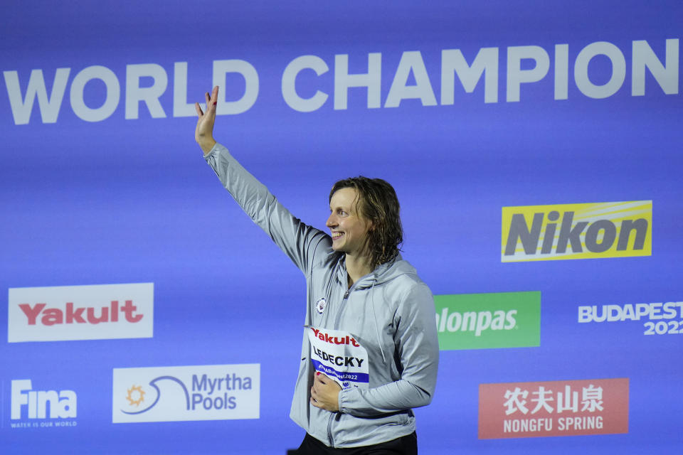 Katie Ledecky of the United States waves from the podium after winning the Women 1500m Freestyle final at the 19th FINA World Championships in Budapest, Hungary, Monday, June 20, 2022. (AP Photo/Petr David Josek)