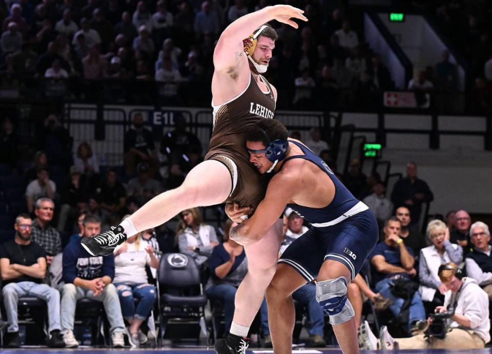 Penn State’s Greg Kerkvliet lifts and drives Lehigh’s Nathan Taylor (285 lbs) to the mat during Sunday’s match at Rec Hall at Penn State. Kerkvliet won by major decision (11-1). Penn State defeated Lehigh, 30-10.