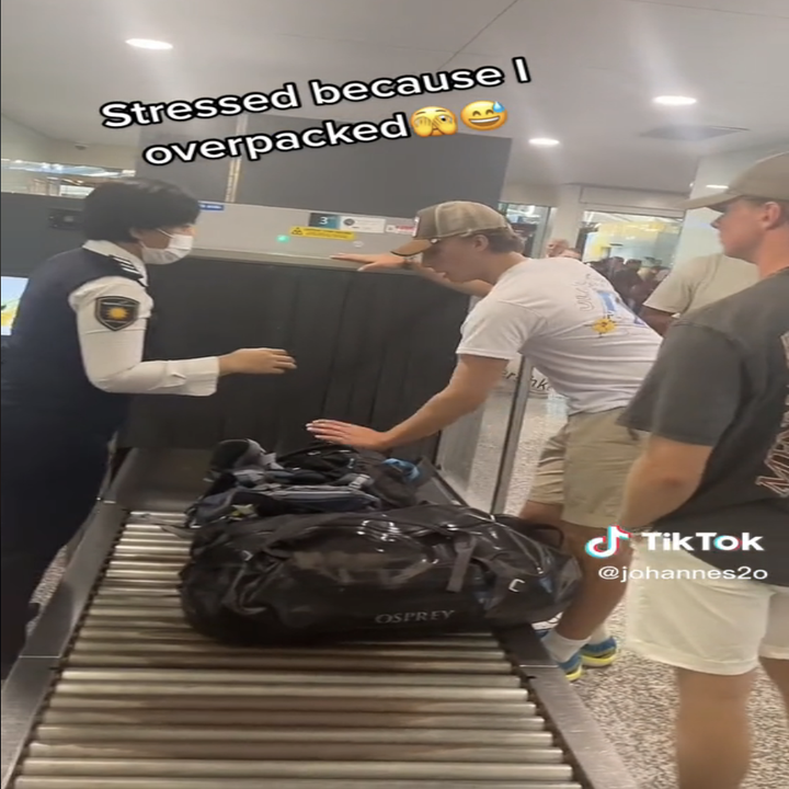 Man putting his luggage on the conveyor with text 