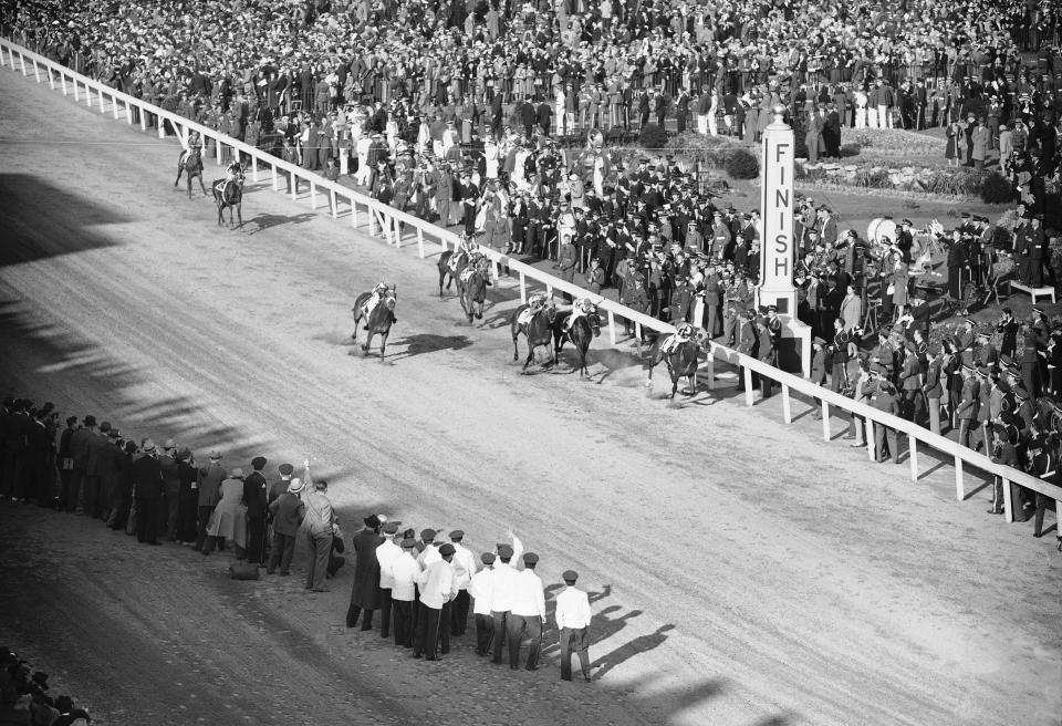 FILE - Gallahadion, with Bimelech second and Dit a close third crosses the finish line to win the 66th Kentucky Derby horse race, May 4, 1940 at Churchill Downs, Louisville, Ky. The Derby has survived two world wars, the Great Depression, and pandemics, including COVID-19 in 2020, when it ran in virtual silence without the usual crowd of 150,000. (AP Photo/FIle)