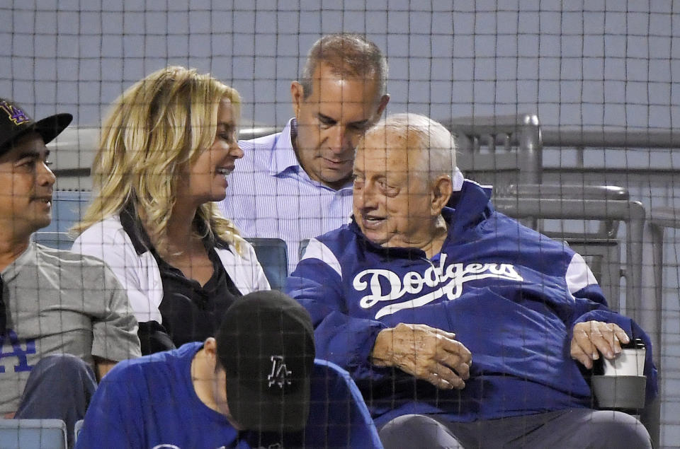 Los Angeles Lakers president Jeanie Buss, left, talks with former Los Angeles Dodgers manager Tommy Lasorda during the fourth inning of a baseball game between the Dodgers and the San Francisco Giants on Wednesday, Aug. 15, 2018, in Los Angeles. (AP Photo/Mark J. Terrill)