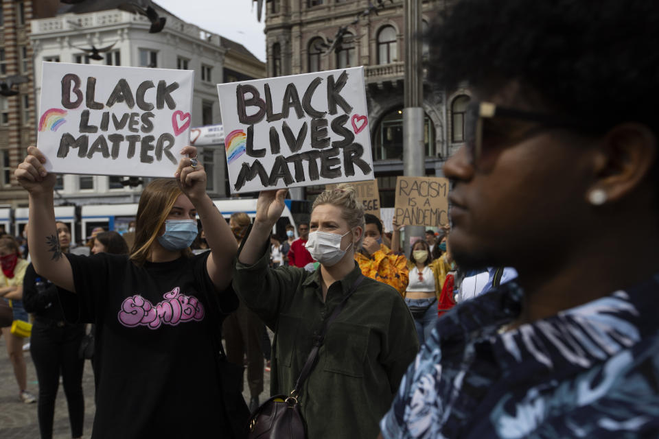 People take part in a Black Lives Matter protest in Amsterdam, Netherlands, Monday, June 1, 2020, to protest against the recent killing of George Floyd, a black man who died in police custody in Minneapolis, U.S.A., after being restrained by police officers on Memorial Day. (AP Photo/Peter Dejong)