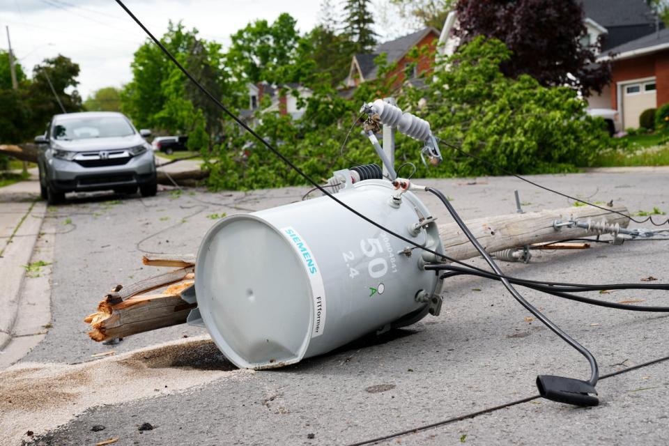 Hydro infrastructure and trees sit broken on a street in the Ottawa Valley municipality of Carleton Place, Ont. on Monday, May 23, 2022. A major storm hit the parts of Ontario and Quebec on Saturday, May 21, 2022, leaving extensive damage to infrastructure. 