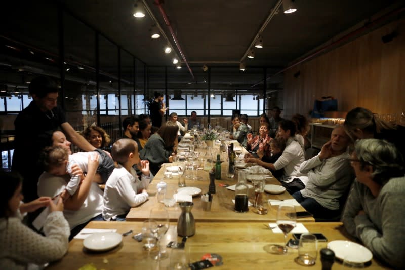 Holocaust survivor Artemis Miron, 91, gestures while celebrating her birthday with family members at a restuarant in Yehud, Israel