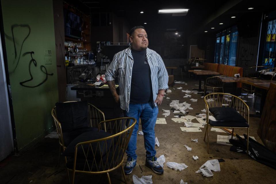 Owner Beto Mendez stands inside his vandalized restaurant.