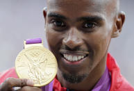 FILE - Britain's Mo Farah poses with his gold medal in the men's 10,000 meters during the athletics in the Olympic Stadium at the 2012 Summer Olympics, London, Sunday, Aug. 5, 2012. It is hard to be first. Mo Farah this week went from being a gold medal-winning runner to the most prominent person ever to come forward as a victim of people trafficking. The four-time Olympic champion’s decision to tell the story of how he was exploited as a child gives a face to the often faceless victims of modern slavery, highlighting a crime that is often conflated with illegal immigration. (AP Photo/Luca Bruno, File)