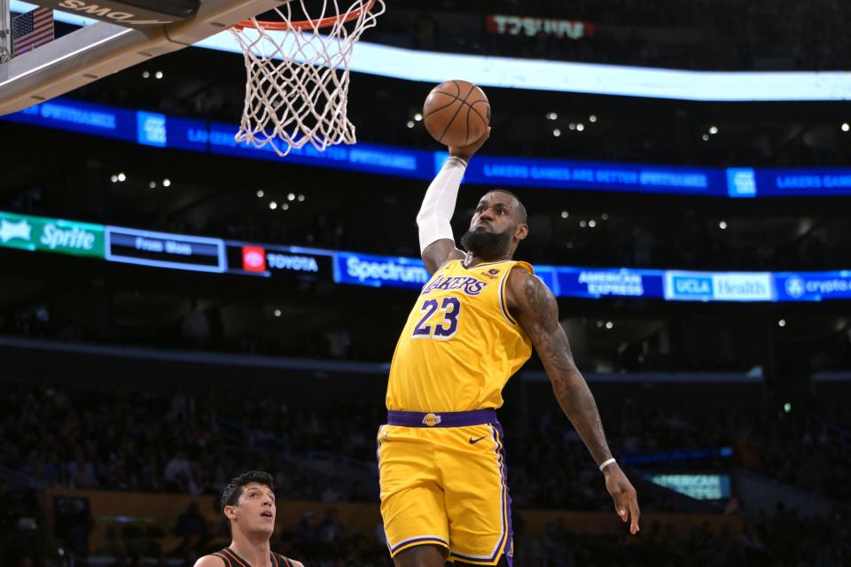 Lakers forward LeBron James (23) goes up for a dunk during the first half against the Pistons at Crypto.com Arena in Los Angeles on Feb. 13, 2024.