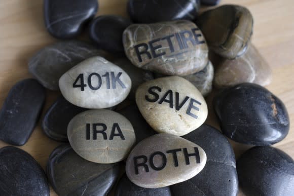 smooth stones on which are written save, retire, roth, ira, 401k