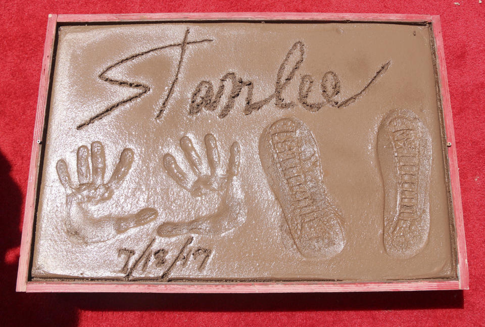 Stan Lee places his feet and hands in cement at the TCL Chinese Theatre on July 18, 2017, in Hollywood.