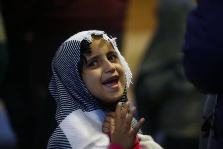 A migrant girl reacts waiting for a train to Hegyeshalom at the railway station in the town of Gyor, Hungary, September 5, 2015. REUTERS/Leonhard Foeger