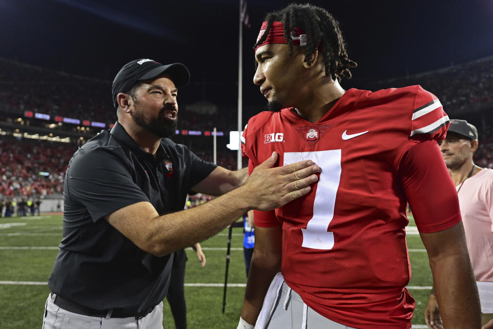 Ohio State coach Ryan Day, left, pats quarterback C.J. Stroud on the chest after Ohio State defeated Notre Dame 21-10 in an NCAA college football game Saturday, Sept. 3, 2022, in Columbus, Ohio. (AP Photo/David Dermer)