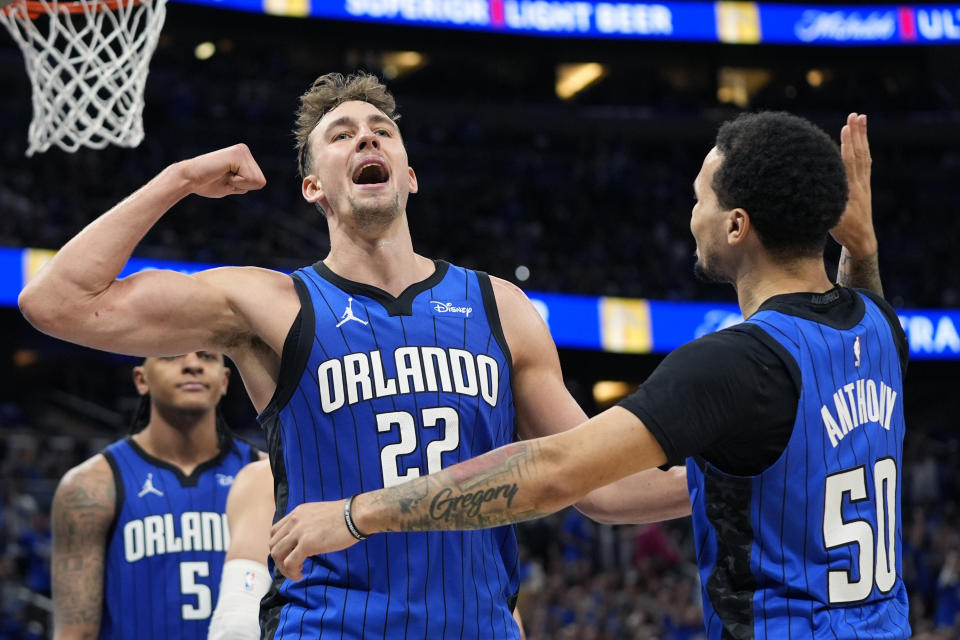 Orlando Magic forward Franz Wagner (22) celebrates with guard Cole Anthony (50) after making a basket and drawing a foul during the second half against the Cleveland Cavaliers in Game 4 of an NBA basketball first-round playoff series, Saturday, April 27, 2024, in Orlando, Fla. (AP Photo/John Raoux)