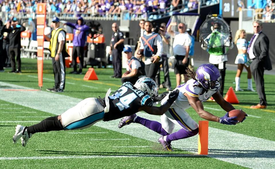 Minnesota Vikings wide receiver K.J. Osborn, right, scores the game winning touchdown as Carolina Panthers safety Sean Chandler, left, futilely attempts to make the tackle during overtime at Bank of America Stadium in Charlotte, NC on Sunday, October 17, 2021. The Vikings defeated the Panthers 34-28.