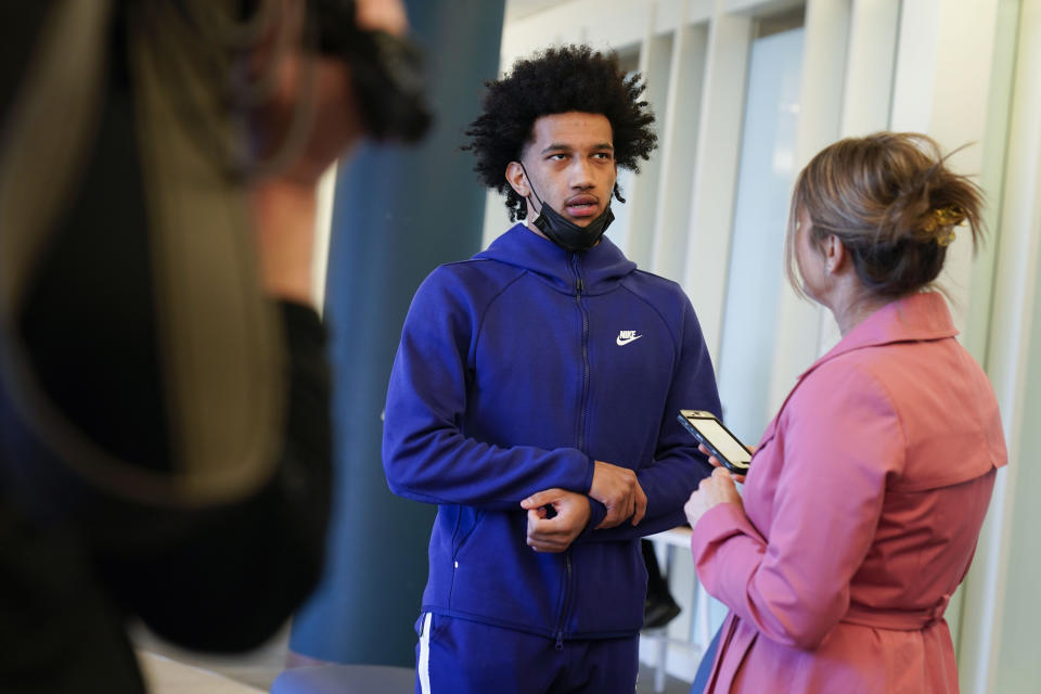 Saint Peter's University basketball player Matthew Lee talks with reporters at the student center on campus in Jersey City, N.J., Monday, March 21, 2022. (AP Photo/Seth Wenig)